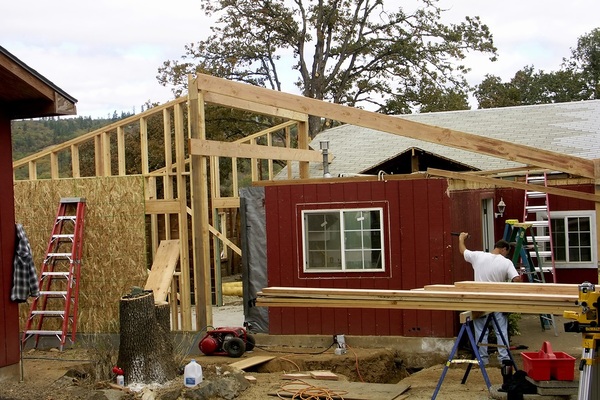 Construction workers building an addition on a house.